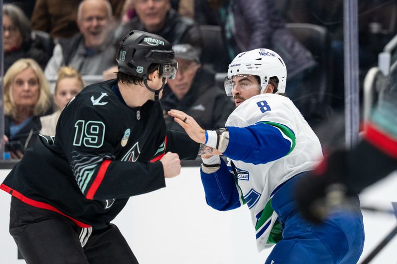Dec 29, 2025; Seattle, Washington, USA; Vancouver Canucks forward Conor Garland (8) and Seattle Kraken forward Jared McCann (19) fight during the first period at Climate Pledge Arena. Mandatory Credit: Stephen Brashear-Imagn Images