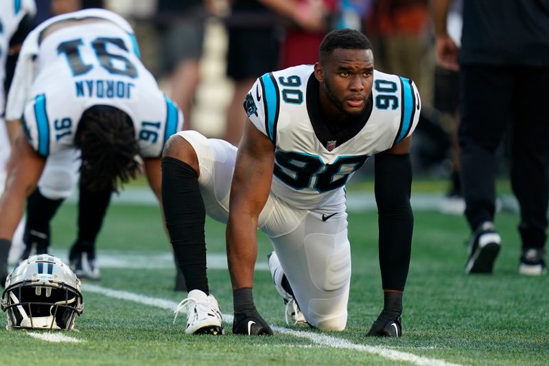 Carolina Panthers defensive lineman Amare Barno (90) stretches prior to a preseason NFL football game against the New England Patriots, Friday, Aug. 19, 2022, in Foxborough, Mass. (AP Photo/Charles Krupa)