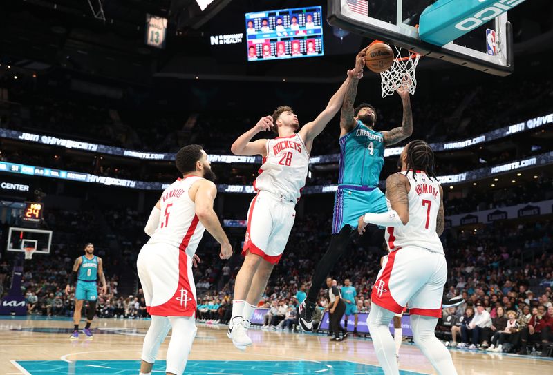 CHARLOTTE, NC - JANUARY 26:  Nick Richards #4 of the Charlotte Hornets grabs a rebound during the game against the Houston Rockets on January 26, 2024 at Spectrum Center in Charlotte, North Carolina. NOTE TO USER: User expressly acknowledges and agrees that, by downloading and or using this photograph, User is consenting to the terms and conditions of the Getty Images License Agreement.  Mandatory Copyright Notice:  Copyright 2024 NBAE (Photo by Brock Williams-Smith/NBAE via Getty Images)