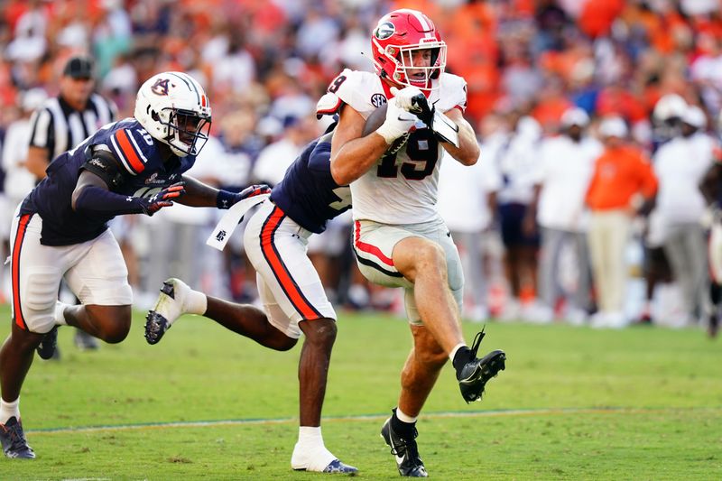 Sep 30, 2023; Auburn, Alabama, USA; Georgia Bulldogs tight end Brock Bowers (19) breaks tackles as he carries a touchdown reception against the Auburn Tigers during the fourth quarter at Jordan-Hare Stadium. Mandatory Credit: John David Mercer-USA TODAY Sports