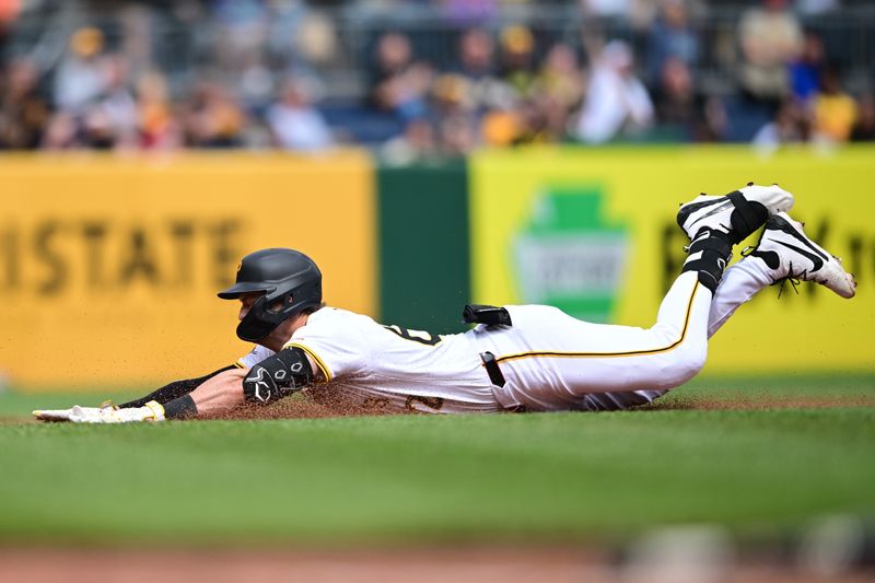 May 4, 2025; Pittsburgh, Pennsylvania, USA; Pittsburgh Pirates first basemen Matthew Gorski (62) slides into third base after hitting a triple during the seventh inning against the Pittsburgh Pirates at PNC Park. Mandatory Credit: David Dermer-Imagn Images
