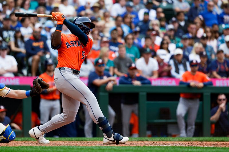 Jul 20, 2025; Seattle, Washington, USA; Houston Astros center fielder Taylor Trammell (26) hits a two-run double against the Seattle Mariners during the seventh inning at T-Mobile Park. Mandatory Credit: Joe Nicholson-Imagn Images