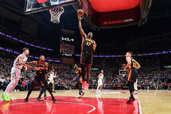 ATLANTA, GA - DECEMBER 11: Onyeka Okongwu #17 of the Atlanta Hawks grabs a rebound during the game against the Denver Nuggets on December 11, 2023 at State Farm Arena in Atlanta, Georgia.  NOTE TO USER: User expressly acknowledges and agrees that, by downloading and/or using this Photograph, user is consenting to the terms and conditions of the Getty Images License Agreement. Mandatory Copyright Notice: Copyright 2023 NBAE (Photo by Scott Cunningham/NBAE via Getty Images)