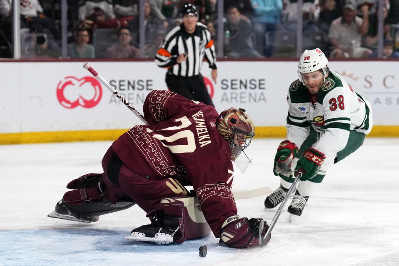 Mar 12, 2023; Tempe, Arizona, USA; Arizona Coyotes goaltender Karel Vejmelka (70) makes a save against Minnesota Wild right wing Ryan Hartman (38) during the first period at Mullett Arena. Mandatory Credit: Joe Camporeale-USA TODAY Sports