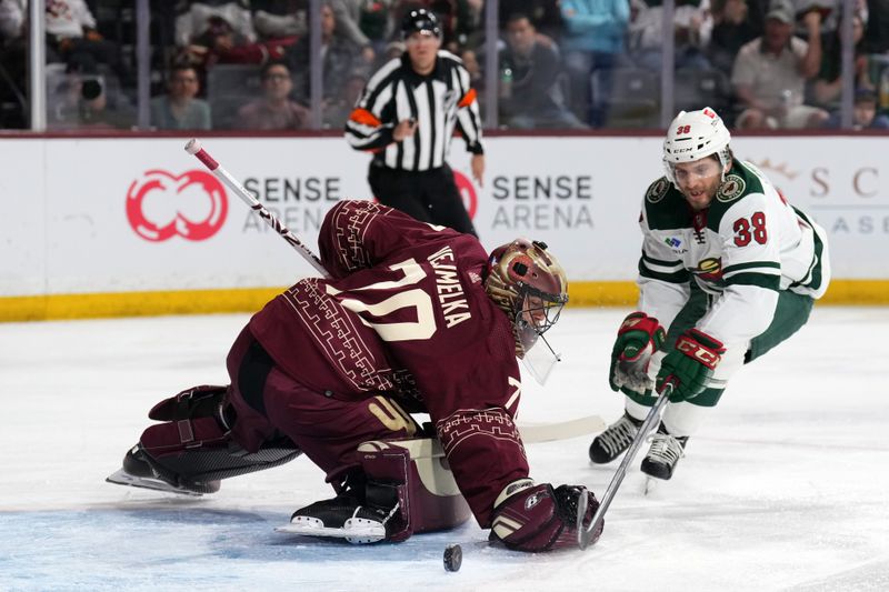 Mar 12, 2023; Tempe, Arizona, USA; Arizona Coyotes goaltender Karel Vejmelka (70) makes a save against Minnesota Wild right wing Ryan Hartman (38) during the first period at Mullett Arena. Mandatory Credit: Joe Camporeale-USA TODAY Sports