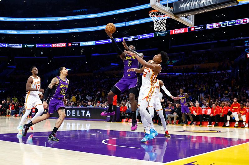 LOS ANGELES, CALIFORNIA - JANUARY 06:  LeBron James #6 of the Los Angeles Lakers takes a shot against De'Andre Hunter #12 of the Atlanta Hawks in the second half at Crypto.com Arena on January 06, 2023 in Los Angeles, California.  NOTE TO USER: User expressly acknowledges and agrees that, by downloading and/or using this photograph, user is consenting to the terms and conditions of the Getty Images License Agreement.  (Photo by Ronald Martinez/Getty Images)