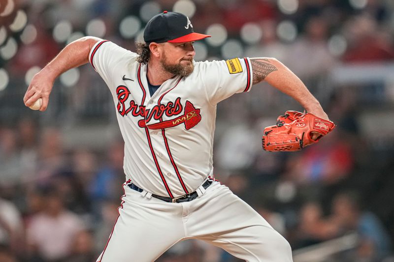 Aug 23, 2023; Cumberland, Georgia, USA; Atlanta Braves relief pitcher Kirby Yates (22) pitches against the New York Mets during the ninth inning at Truist Park. Mandatory Credit: Dale Zanine-USA TODAY Sports