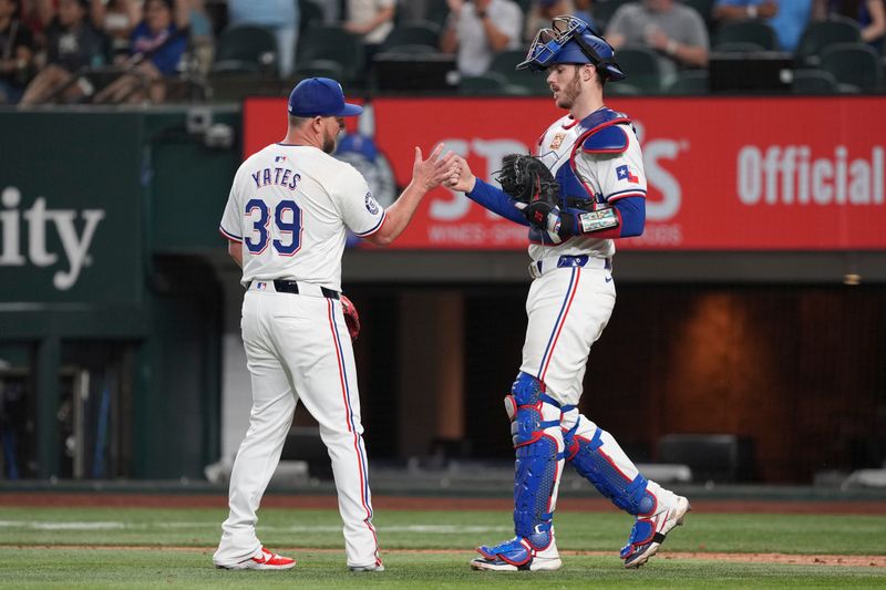 Sep 7, 2024; Arlington, Texas, USA; Texas Rangers relief pitcher Kirby Yates (39) and catcher Jonah Heim (28) celebrate after defeating the Los Angeles Angels at Globe Life Field. Mandatory Credit: Jim Cowsert-Imagn Images