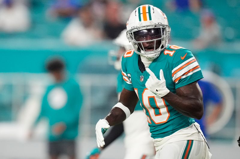 Miami Dolphins wide receiver Tyreek Hill (10) warms up before an NFL football game against the Buffalo Bills, Thursday, Sept. 12, 2024, in Miami Gardens, Fla. (AP Photo/Rebecca Blackwell)