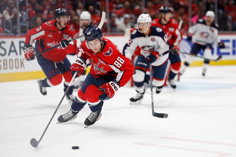 Nov 2, 2024; Washington, District of Columbia, USA; Washington Capitals left wing Andrew Mangiapane (88) skates with the puck from Columbus Blue Jackets right wing Kevin Labanc (62) in the second period at Capital One Arena. Mandatory Credit: Geoff Burke-Imagn Images