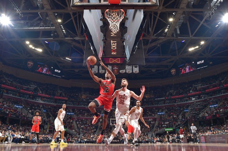 CLEVELAND, OH - JANUARY 15: Ayo Dosunmu #12 of the Chicago Bulls drives to the basket during the game against the Cleveland Cavaliers on January 15, 2024 at Rocket Mortgage FieldHouse in Cleveland, Ohio. NOTE TO USER: User expressly acknowledges and agrees that, by downloading and/or using this Photograph, user is consenting to the terms and conditions of the Getty Images License Agreement. Mandatory Copyright Notice: Copyright 2024 NBAE (Photo by David Liam Kyle/NBAE via Getty Images)