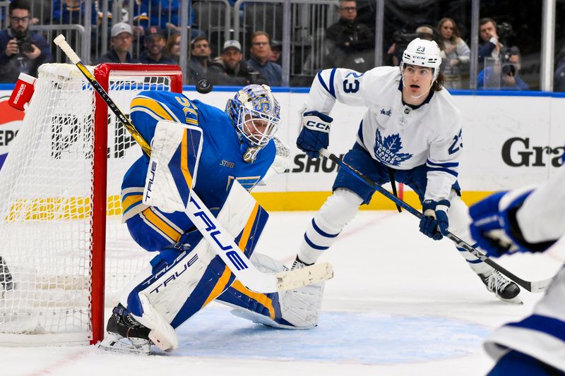 Nov 2, 2024; St. Louis, Missouri, USA;  St. Louis Blues goaltender Jordan Binnington (50) defends the net against Toronto Maple Leafs left wing Matthew Knies (23) during the third period at Enterprise Center. Mandatory Credit: Jeff Curry-Imagn Images