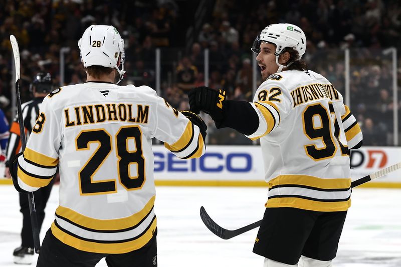 Jan 10, 2026; Boston, Massachusetts, USA; Boston Bruins center Marat Khusnutdinov (92) is congratulated by center Elias Lindholm (28) after scoring against the New York Rangers during the first period at TD Garden. Mandatory Credit: Winslow Townson-Imagn Images