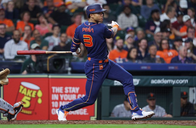 May 1, 2023; Houston, Texas, USA; Houston Astros shortstop Jeremy Pena (3) hits a single during the sixth inning against the San Francisco Giants at Minute Maid Park. Mandatory Credit: Troy Taormina-USA TODAY Sports