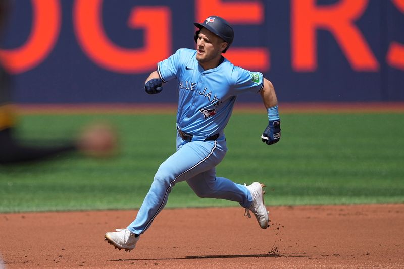 Jun 1, 2024; Toronto, Ontario, CAN; Toronto Blue Jays center fielder Daulton Varsho (25) runs to second base after hitting a triple against the Pittsburgh Pirates during the first inning at Rogers Centre. Mandatory Credit: John E. Sokolowski-USA TODAY Sports