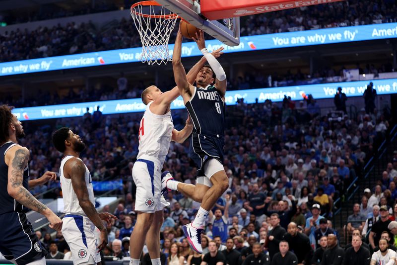 DALLAS, TEXAS - APRIL 28: Josh Green #8 of the Dallas Mavericks shoots the ball while defended by Mason Plumlee #44 of the Los Angeles Clippers in the first half of game four of the Western Conference First Round Playoffs at American Airlines Center on April 28, 2024 in Dallas, Texas.  NOTE TO USER: User expressly acknowledges and agrees that, by downloading and or using this photograph, User is consenting to the terms and conditions of the Getty Images License Agreement. (Photo by Tim Warner/Getty Images)