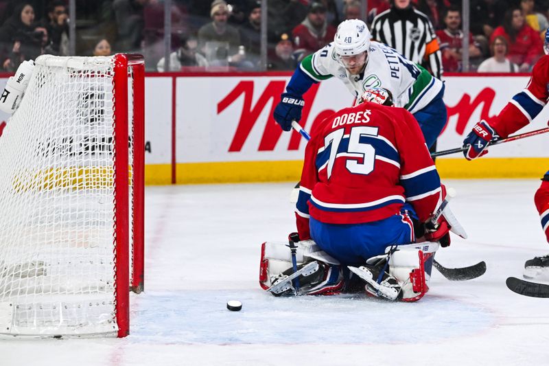 Jan 12, 2026; Montreal, Quebec, CAN; Vancouver Canucks center Elias Pettersson (40) scores a goal against Montreal Canadiens goalie Jakub Dobes (75) during the first period at Bell Centre. Mandatory Credit: David Kirouac-Imagn Images