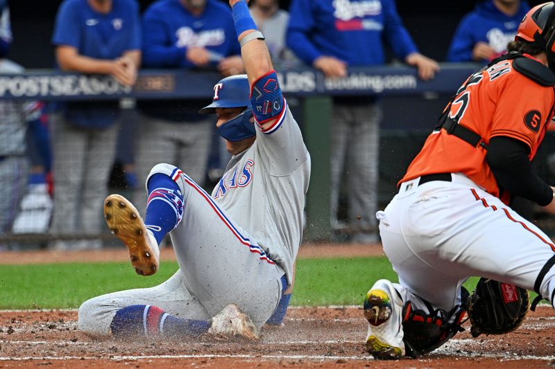 Oct 8, 2023; Baltimore, Maryland, USA; Texas Rangers third baseman Josh Jung (6) slides into home plate to scores a run during the second inning against the Baltimore Orioles during game two of the ALDS for the 2023 MLB playoffs at Oriole Park at Camden Yards. Mandatory Credit: Tommy Gilligan-USA TODAY Sports