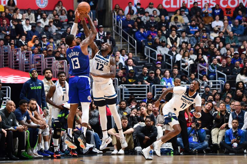 LOS ANGELES, CA - FEBRUARY 28: Taurean Prince #12 of the Minnesota Timberwolves blocks Paul George #13 of the LA Clippers during the game on February 28, 2023 at Crypto.Com Arena in Los Angeles, California. NOTE TO USER: User expressly acknowledges and agrees that, by downloading and/or using this Photograph, user is consenting to the terms and conditions of the Getty Images License Agreement. Mandatory Copyright Notice: Copyright 2023 NBAE (Photo by Adam Pantozzi/NBAE via Getty Images)