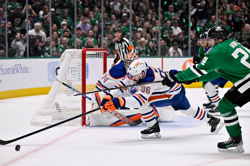 May 23, 2025; Dallas, Texas, USA; Edmonton Oilers defenseman Jake Walman (96) gets the puck from Dallas Stars center Roope Hintz (24) in the second period for game two of the Western Conference Final of the 2025 Stanley Cup Playoffs at American Airlines Center. Mandatory Credit: Jerome Miron-Imagn Images