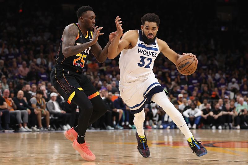 PHOENIX, ARIZONA - APRIL 28: Karl-Anthony Towns #32 of the Minnesota Timberwolves drives the ball against Nassir Little #25 of the Phoenix Sunsduring the first half of game four of the Western Conference First Round Playoffs at Footprint Center on April 28, 2024 in Phoenix, Arizona. NOTE TO USER: User expressly acknowledges and agrees that, by downloading and or using this photograph, User is consenting to the terms and conditions of the Getty Images License Agreement.  (Photo by Christian Petersen/Getty Images)