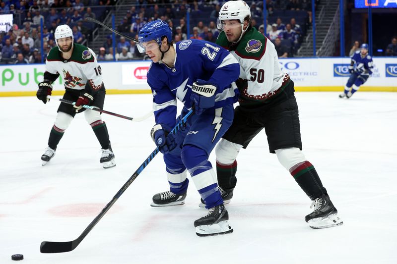 Jan 25, 2024; Tampa, Florida, USA; Tampa Bay Lightning center Brayden Point (21) skates with the puck as Arizona Coyotes defenseman Sean Durzi (50) defends during the first period at Amalie Arena. Mandatory Credit: Kim Klement Neitzel-USA TODAY Sports