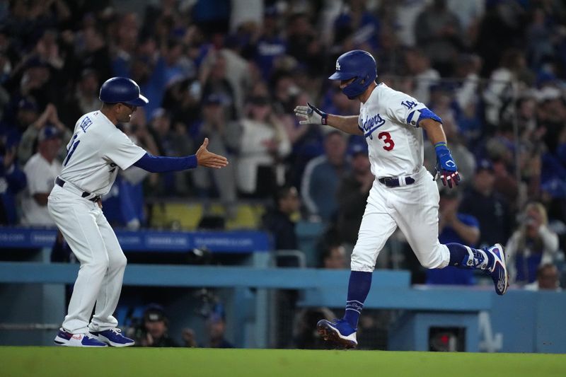 Jun 15, 2023; Los Angeles, California, USA; Los Angeles Dodgers third baseman Chris Taylor (3) is congratulated by third base coach Dino Ebel (91) after hitting a grand slam home run in the sixth inning against the Chicago White Sox at Dodger Stadium. Mandatory Credit: Kirby Lee-USA TODAY Sports