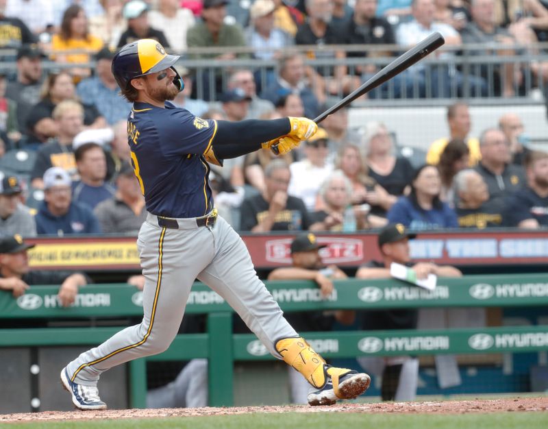 Sep 26, 2024; Pittsburgh, Pennsylvania, USA;  Milwaukee Brewers catcher Eric Haase (13) hits an RBI double against the Pittsburgh Pirates during the fifth inning at PNC Park. Mandatory Credit: Charles LeClaire-Imagn Images