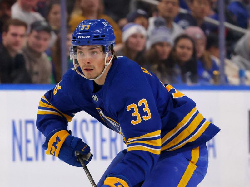 Jan 13, 2024; Buffalo, New York, USA;  Buffalo Sabres defenseman Ryan Johnson (33) skates up ice with the puck during the second period against the Vancouver Canucks at KeyBank Center. Mandatory Credit: Timothy T. Ludwig-USA TODAY Sports