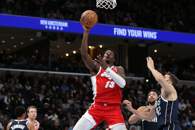 MEMPHIS, TENNESSEE - JANUARY 06: Jaren Jackson Jr. #13 of the Memphis Grizzlies goes to the basket against Maxi Kleber #42 of the Dallas Mavericks during the second half at FedExForum on January 06, 2025 in Memphis, Tennessee. NOTE TO USER: User expressly acknowledges and agrees that, by downloading and or using this photograph, User is consenting to the terms and conditions of the Getty Images License Agreement. (Photo by Justin Ford/Getty Images)