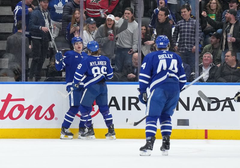 Apr 8, 2024; Toronto, Ontario, CAN; Toronto Maple Leafs left wing Matthew Knies (23) scores a goal and celebrates with right wing William Nylander (88) against the Pittsburgh Penguins during the second period at Scotiabank Arena. Mandatory Credit: Nick Turchiaro-USA TODAY Sports