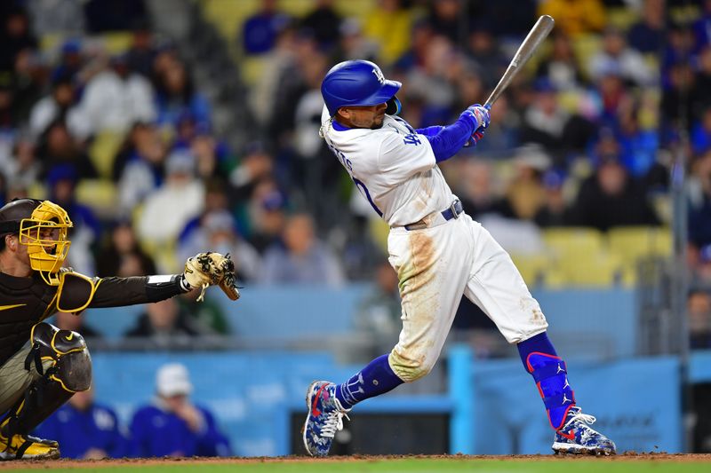 Apr 13, 2024; Los Angeles, California, USA; Los Angeles Dodgers shortstop Mookie Betts (50) hits an RBI single against the San Diego Padres during the fourth inning at Dodger Stadium. Mandatory Credit: Gary A. Vasquez-USA TODAY Sports