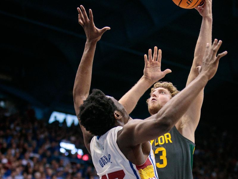 Feb 18, 2023; Lawrence, Kansas, USA; Baylor Bears forward Caleb Lohner (33) puts up a shot over Kansas Jayhawks center Ernest Udeh Jr. (23) during the first half at Allen Fieldhouse. Mandatory Credit: William Purnell-USA TODAY Sports