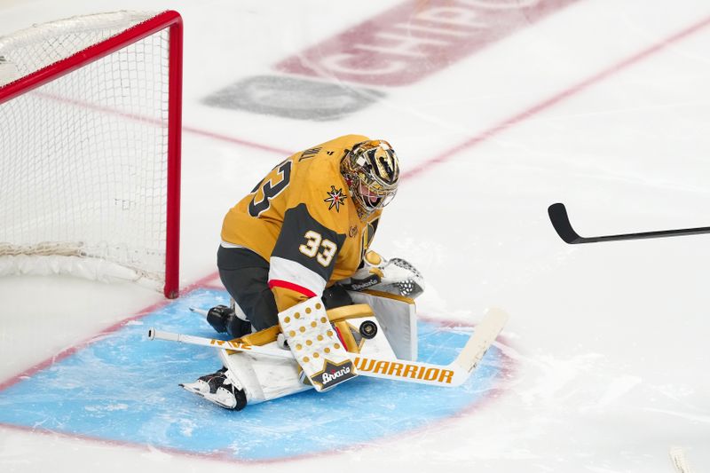 May 14, 2025; Las Vegas, Nevada, USA; Vegas Golden Knights goaltender Adin Hill (33) makes a save the Edmonton Oilers during the third period of game five of the second round of the 2025 Stanley Cup Playoffs at T-Mobile Arena. Mandatory Credit: Stephen R. Sylvanie-Imagn Images