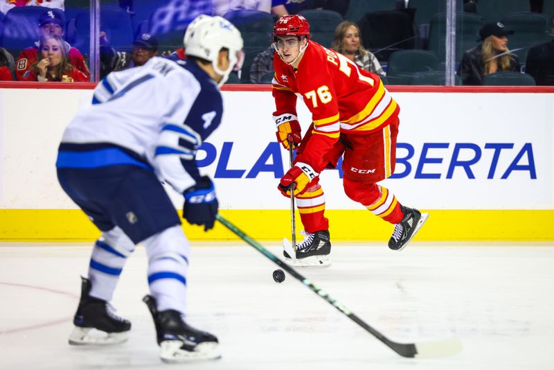 Oct 4, 2024; Calgary, Alberta, CAN; Calgary Flames center Martin Pospisil (76) controls the puck against the Winnipeg Jets during the second period at Scotiabank Saddledome. Mandatory Credit: Sergei Belski-Imagn Images