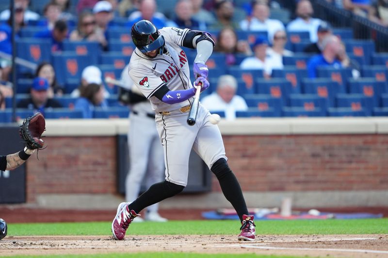 May 31, 2024; New York City, New York, USA; Arizona Diamondbacks left fielder Lourdes Gurriel Jr. (12) hits an RBI single against the New York Mets during the first inning at Citi Field. Mandatory Credit: Gregory Fisher-USA TODAY Sports