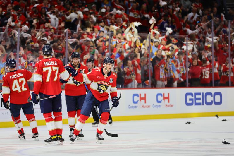 Jun 8, 2024; Sunrise, Florida, USA; Florida Panthers forward Eetu Luostarinen (27) celebrates scoring an empty net goal from the red line against the Edmonton Oilers during the third period in game one of the 2024 Stanley Cup Final at Amerant Bank Arena. Mandatory Credit: Sam Navarro-USA TODAY Sports