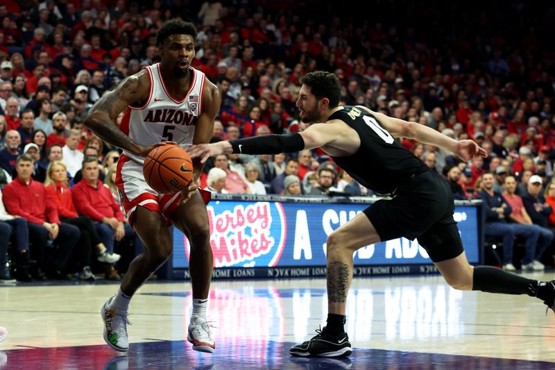 Jan 4, 2024; Tucson, Arizona, USA; Arizona Wildcats guard KJ Lewis (5) drives to the net against Colorado Buffaloes guard Luke O'Brien (0) during the second half at McKale Center. Mandatory Credit: Zachary BonDurant-USA TODAY Sports