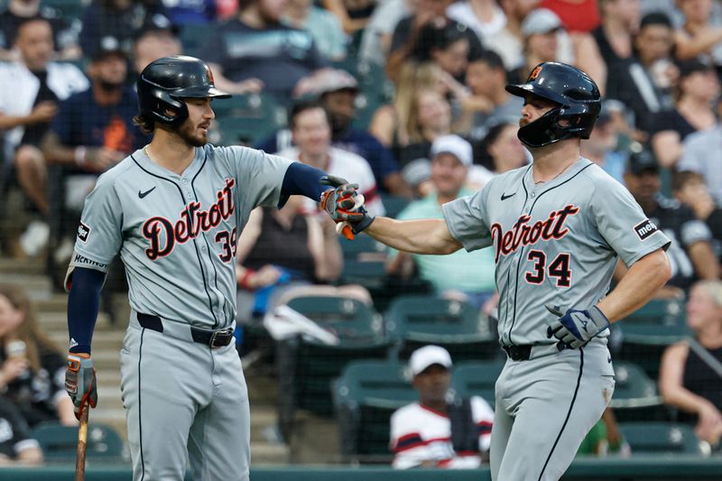 Aug 24, 2024; Chicago, Illinois, USA; Detroit Tigers catcher Jake Rogers (34) celebrates with shortstop Zach McKinstry (39) after scoring against the Chicago White Sox during the third inning at Guaranteed Rate Field. Mandatory Credit: Kamil Krzaczynski-USA TODAY Sports