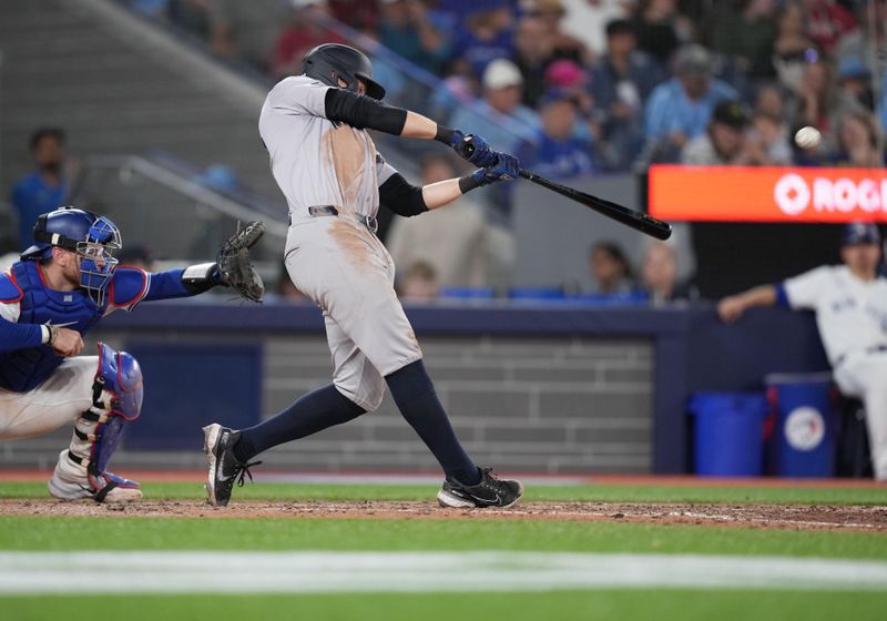 Jun 30, 2024; Toronto, Ontario, CAN; New York Yankees first baseman Ben Rice (93) hits an RBI double against the Toronto Blue Jays during the sixth inning at Rogers Centre. Mandatory Credit: Nick Turchiaro-USA TODAY Sports