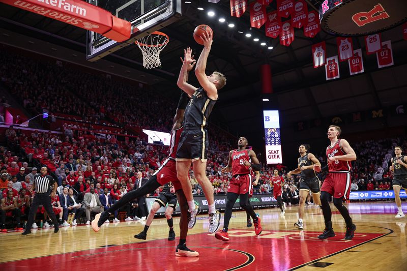 Jan 28, 2024; Piscataway, New Jersey, USA; Purdue Boilermakers forward Caleb Furst (1) shoots the ball as Rutgers Scarlet Knights center Clifford Omoruyi (11) defends during the first half at Jersey Mike's Arena. Mandatory Credit: Vincent Carchietta-USA TODAY Sports