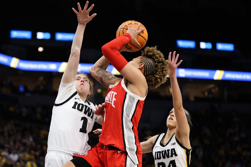 Mar 5, 2023; Minneapolis, MINN, USA; Ohio State Buckeyes guard Rikki Harris (1) shoots while Iowa Hawkeyes guard Molly Davis (1) defends during the second half at Target Center. Mandatory Credit: Matt Krohn-USA TODAY Sports