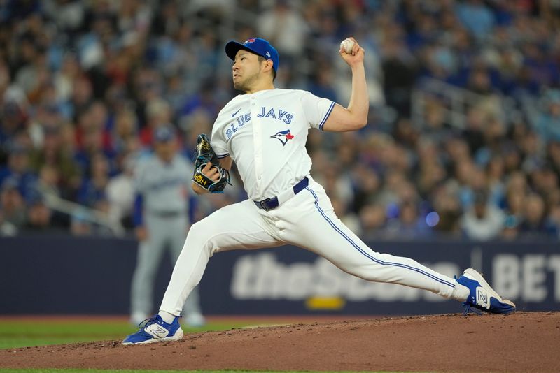 Apr 27, 2024; Toronto, Ontario, CAN; Toronto Blue Jays starting pitcher Yusei Kikuchi (16) pitches to the Los Angeles Dodgers during the second inning at Rogers Centre. Mandatory Credit: John E. Sokolowski-USA TODAY Sports