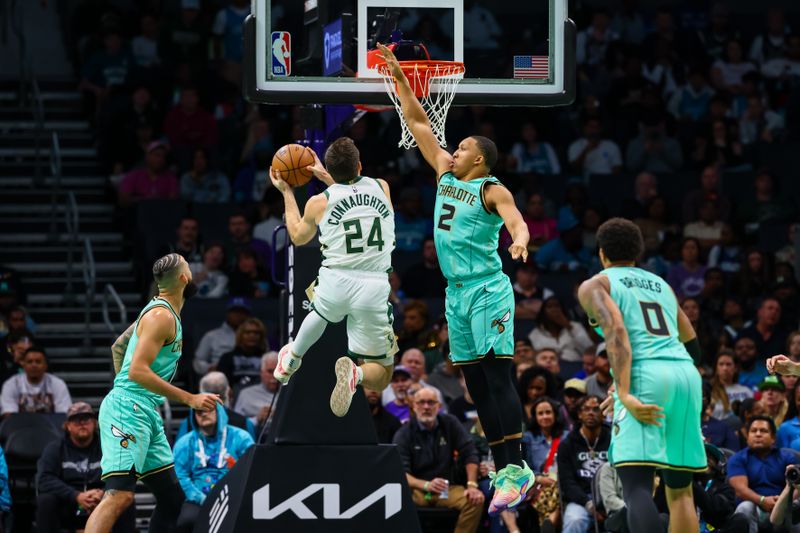 CHARLOTTE, NORTH CAROLINA - NOVEMBER 16: Grant Williams #2 of the Charlotte Hornets defends a shot by Pat Connaughton #24 of the Milwaukee Bucks during the first half of a basketball game at Spectrum Center on November 16, 2024 in Charlotte, North Carolina. NOTE TO USER: User expressly acknowledges and agrees that, by downloading and or using this photograph, User is consenting to the terms and conditions of the Getty Images License Agreement. (Photo by David Jensen/Getty Images)