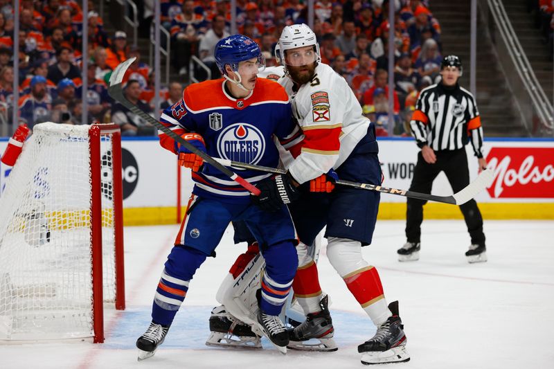 Jun 13, 2024; Edmonton, Alberta, CAN; Edmonton Oilers center Mattias Janmark (13) battles Florida Panthers defenseman Aaron Ekblad (5) for position in the second period in game three of the 2024 Stanley Cup Final at Rogers Place. Mandatory Credit: Perry Nelson-USA TODAY Sports
