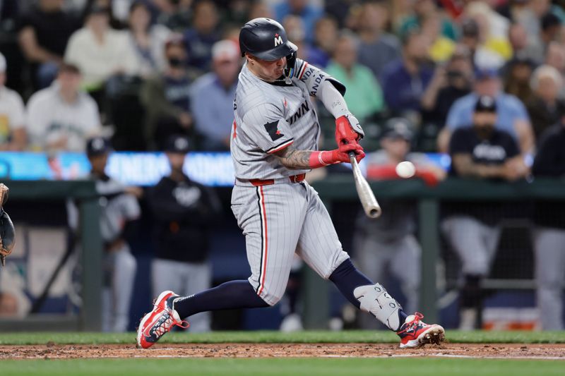 Jun 29, 2024; Seattle, Washington, USA; Minnesota Twins third baseman Jose Miranda (64) hits an RBI single against the Seattle Mariners during the second inning at T-Mobile Park. Mandatory Credit: John Froschauer-USA TODAY Sports