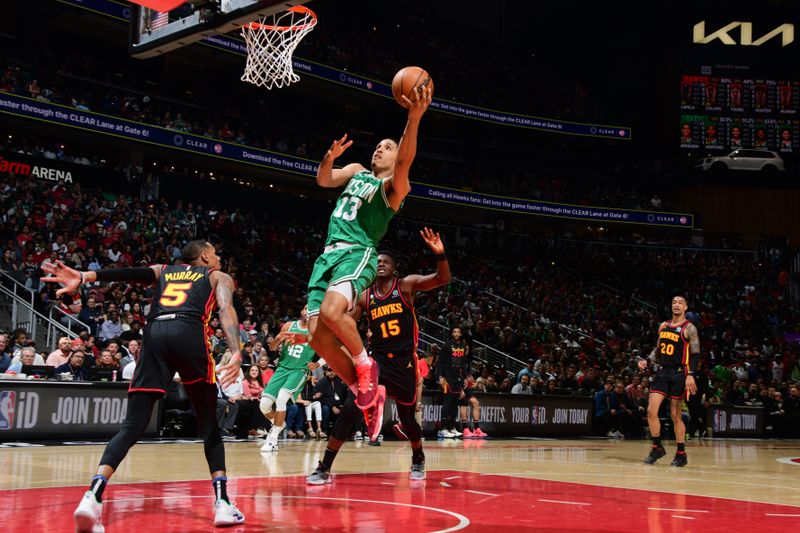 ATLANTA, GA - APRIL 21: Malcolm Brogdon #13 of the Boston Celtics drives to the basket against the Atlanta Hawks during Round 1 Game 3 of the 2023 NBA Playoffs on April 21, 2023 at State Farm Arena in Atlanta, Georgia.  NOTE TO USER: User expressly acknowledges and agrees that, by downloading and/or using this Photograph, user is consenting to the terms and conditions of the Getty Images License Agreement. Mandatory Copyright Notice: Copyright 2023 NBAE (Photo by Scott Cunningham/NBAE via Getty Images)