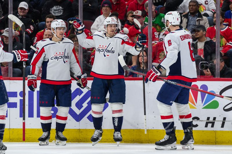 Dec 10, 2023; Chicago, Illinois, USA; Washington Capitals left wing Beck Malenstyn (47) celebrates his goal with right wing Nicolas Aube-Kubel (96) and defenseman Joel Edmundson (6) against the Chicago Blackhawks during the second period at the United Center. Mandatory Credit: Daniel Bartel-USA TODAY Sports