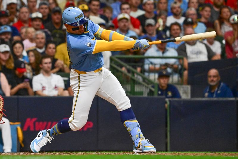 Aug 17, 2024; Milwaukee, Wisconsin, USA; Milwaukee Brewers designated hitter William Contreras (24) hits a solo home run against the Cleveland Guardians in the fourth inning at American Family Field. Mandatory Credit: Benny Sieu-USA TODAY Sports