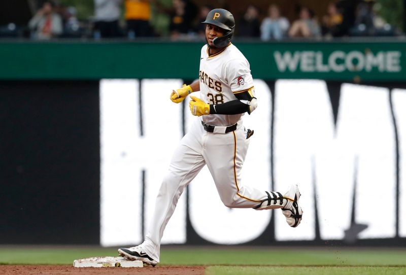 May 6, 2024; Pittsburgh, Pennsylvania, USA;  Pittsburgh Pirates right fielder Edward Olivares (38) circles the bases on a grand slam home run against the Los Angeles Angels during the third inning at PNC Park. Mandatory Credit: Charles LeClaire-USA TODAY Sports